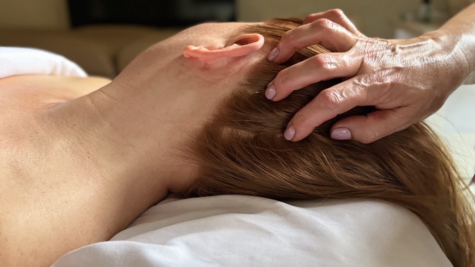 A hand resting at the temple during a session